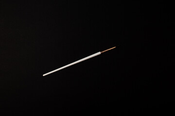 The brush for painting makeup lies on the background