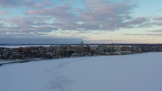 Madison, Wisconsin in Winter Over Lake Monona (Drone - Pull-Back & Tilt Down) 