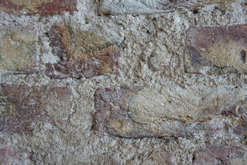 old brick wall with plaster showing