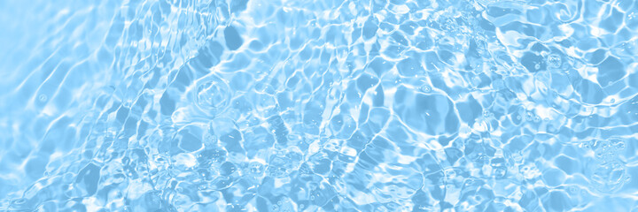 Fresh water background. Bright blue pattern with natural rippled water texture and bubbles. Top...