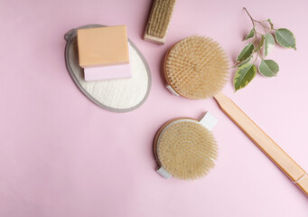 Obraz na płótnie Canvas Zero waste eco friendly cleaning concept. wooden brushes on pink background with natural soap.