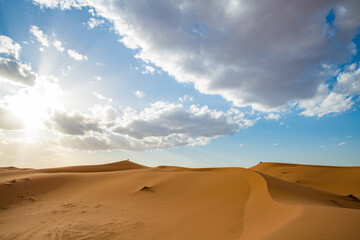Fototapeta na wymiar Sand dunes in Morocco. Erg Chebbi Sahara desert. Yellow red sand and blue sky. High quality photo