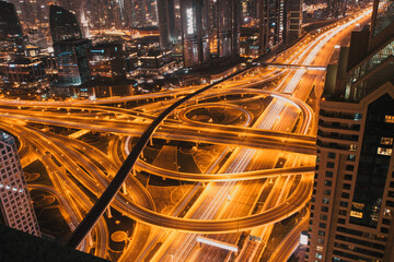 Fototapeta na wymiar DUBAI, UAE - FEBRUARY 2018: Night traffic on a busy intersection on Sheikh Zayed highway