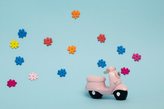 Colorful Flowers On A Blue Background And A Pink Motorbike