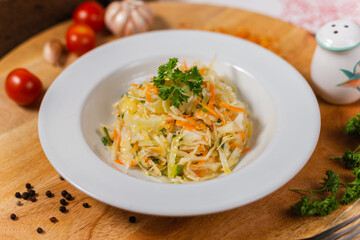 vegetarian cabbage and carrot salad on a white plate