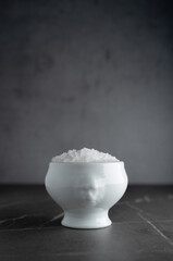 Sea salt in an unusual white ceramic bowl, with free space on top