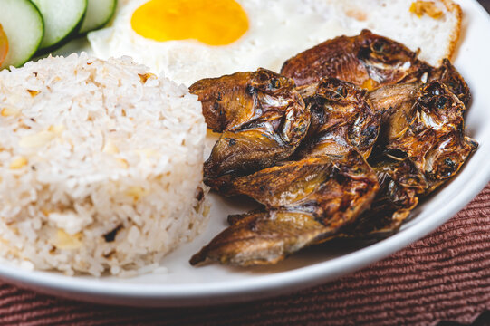 Danggitsilog- is a famous Pinoy breakfast combination of fried Danggit (dried fish), egg, and garlic rice.