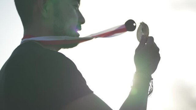 Silhouette Portrait Champion Winner Male Kissing Gold Medal Dramatic Sun Light Slow Motion