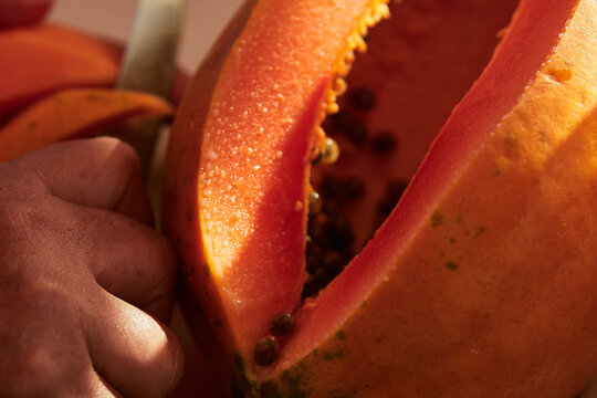 Freshly cut papaya. Fruits cut for salad. Orange papaya for juices. Nutritive breakfast.
