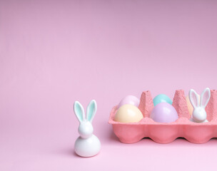 Shot of arrangement decoration Happy Easter holiday on a pink background.Colorful Easter eggs in paper box. Copy space.