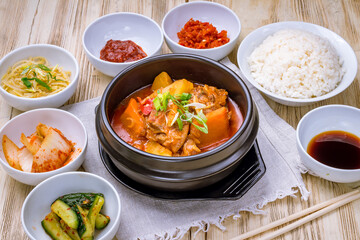 dakturitan korean cuisine on black bowl with spices on wooden table