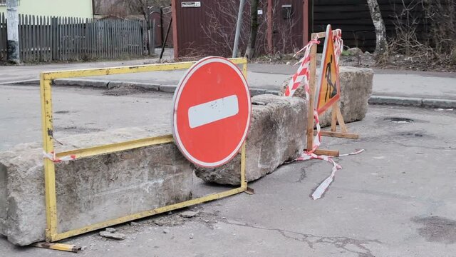 Roadworks signs on a street. Detour arrow. Repair work on the road.