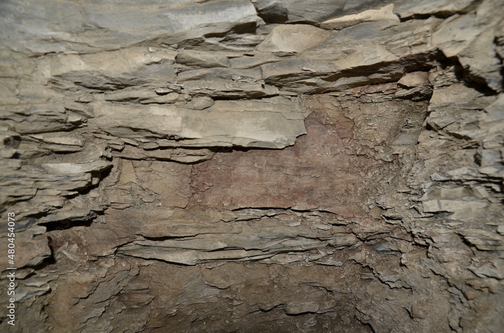 Poster the background consists of a stone massif in layers.