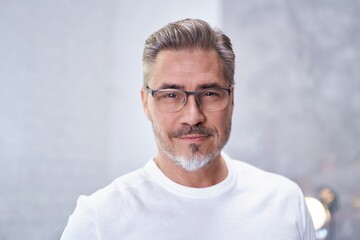 Portrait of mature age, middle age, mid adult casual man at home in glasses, happy smiling....