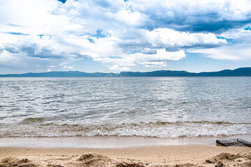 Lake Tahoe in Northern California with Cloudy Blue Skies Overlooking Mountains