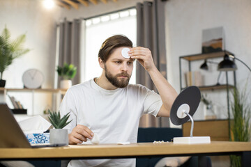 Facial skin care concept where handsome smiling bearded young caucasian guy posing to camera and...