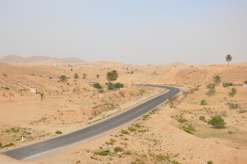 Highway in South Tunisia, Africa Blue sky, deserted yellow hills