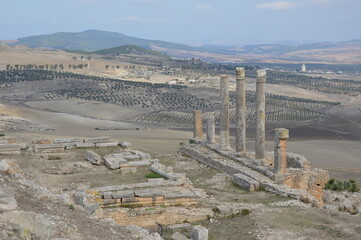 Ruins of  the ancient roman city of Dougga in Tunisia, Africa. Blue sky with clouds, white, grey...