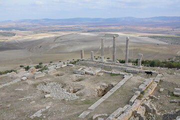 Ruins of  the ancient roman city of Dougga in Tunisia, Africa. Blue sky with clouds, white, grey...