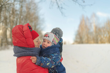 little boy cry on the background of the snow-covered forest mom pity son.