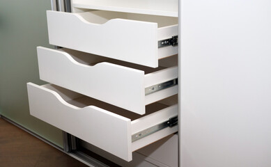Modern open drawers for storage in a cabinet with mortise handles, modern wardrobe, furniture in...