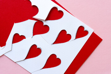 cutout hearts on red and pink paper background
