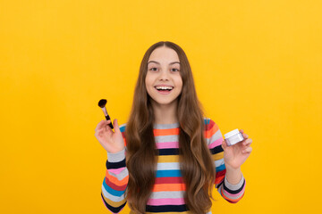 I love changing my makeup. Happy child apply cosmetics. Girl smile using makeup brush. Visage