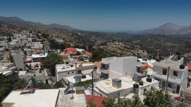Scenic view of rethymno town with mountains on sunny summer day