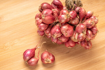 Shallots or Red Onion, Asian herbs and cooking ingredients on wooden background.