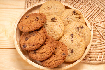 Butter cookies in wooden plate on wooden background, Chocolate Chip Cookies ready to serve.