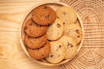 Butter cookies in wooden plate on wooden background, Chocolate Chip Cookies ready to serve.