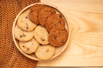 Butter cookies in wooden plate on wooden background, Chocolate Chip Cookies ready to serve.
