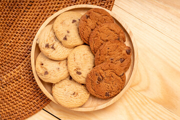 Butter cookies in wooden plate on wooden background, Chocolate Chip Cookies ready to serve.