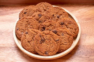 Butter cookies in wooden plate on wooden background, Chocolate Chip Cookies ready to serve.