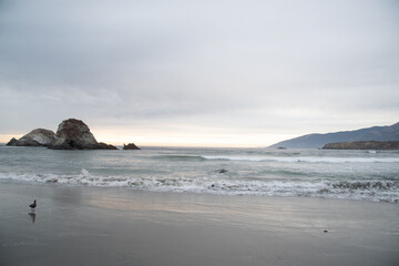 Fototapeta na wymiar Ocean Sunset Through Rocks Along California Coast on Pacific Highway One