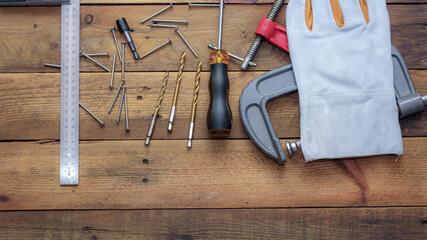 Collection of woodworking tools on a wooden background.