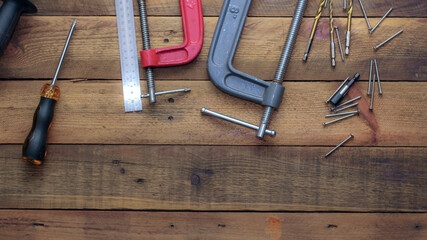 Collection of woodworking tools on a wooden background.