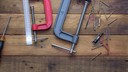 Collection of woodworking tools on a wooden background.