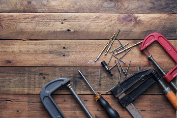 Collection of woodworking tools on a wooden background.