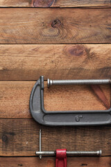 Collection of woodworking tools on a wooden background.