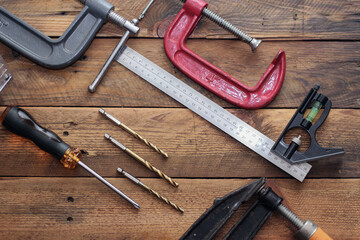 Collection of woodworking tools on a wooden background.