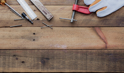 Collection of woodworking tools on a wooden background.