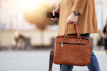 Businessman with briefcase outdoor - obrazy, fototapety, plakaty