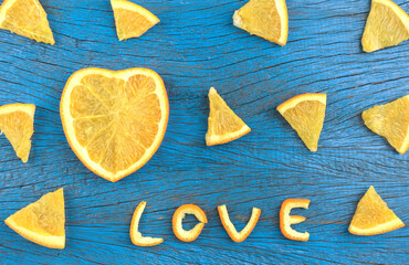 Slices of orange on the day of love on the wooden floor turquoise Selective focus,