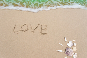 Fototapeta na wymiar Love is written on the beach.