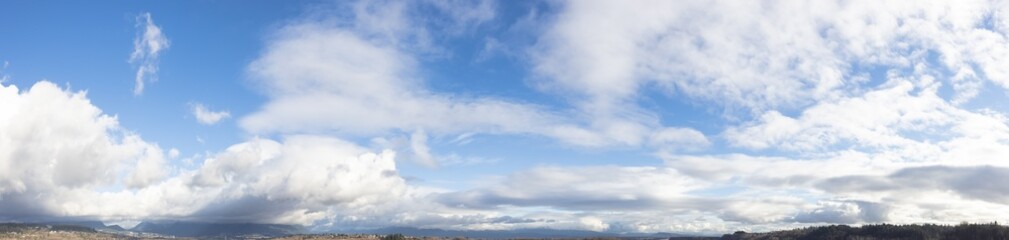 Panoramic View of Cloudscape during a cloudy blue sky sunny day. Taken over the Fraser River in...