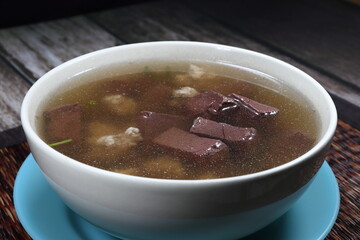 Hot and clear soup of pork blood and minced pork with fat floating on soup surface.