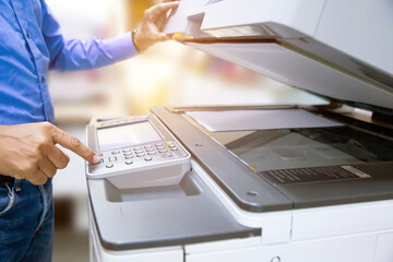 Copier printer, Close up hand office man press copy button on panel to using the copier or photocopier machine for scanning document printing a sheet paper and xerox photocopy.