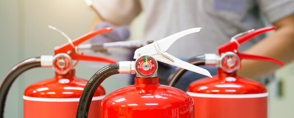 Fire extinguisher, Engineer inspection checking pressure gauge level fire extinguisher tank for protection and prevent emergency and safety rescue and fire alarm system training.