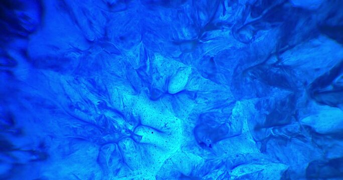 Blue ink and paint liquid reaction abstract texture background 